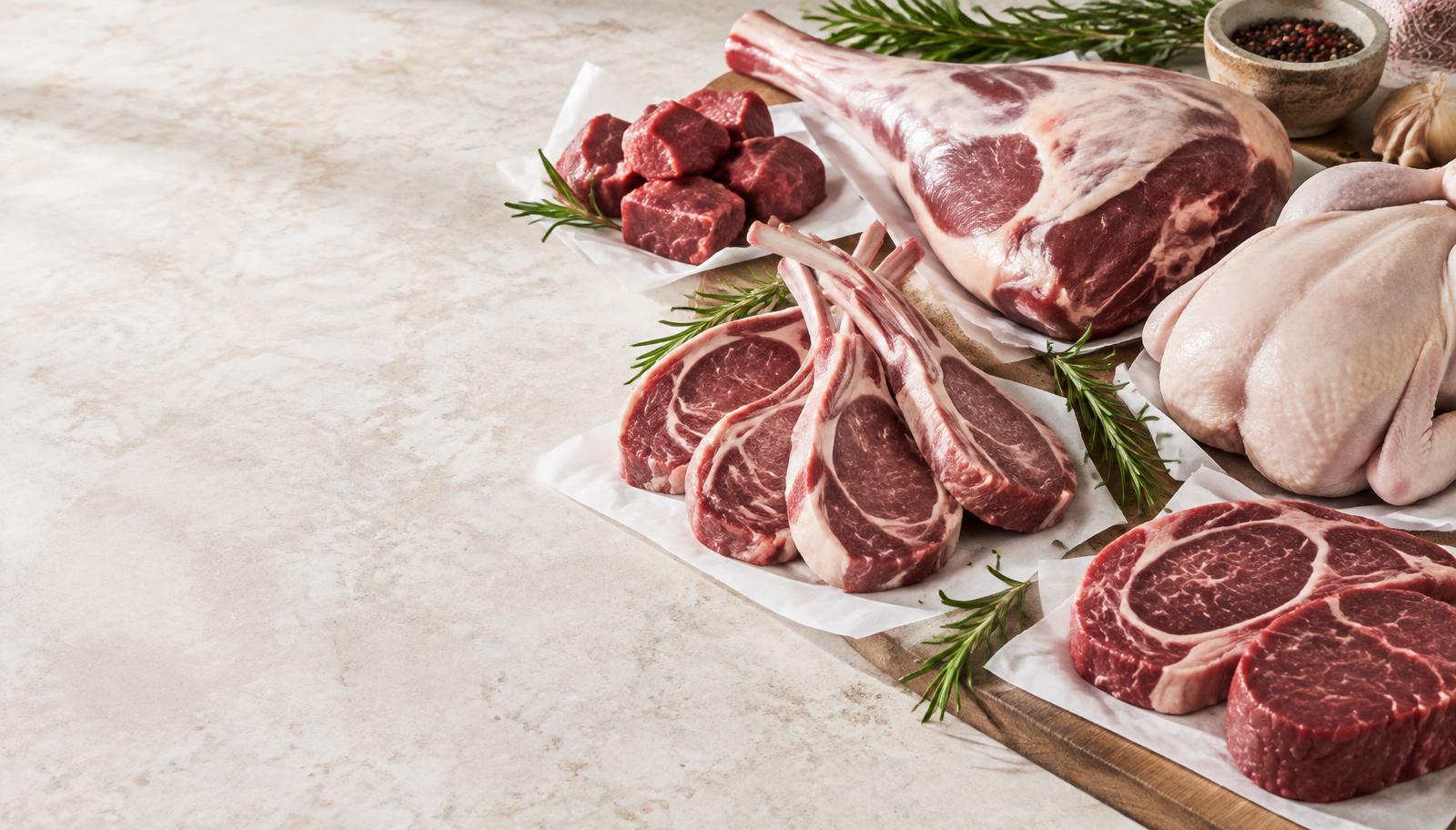 Fresh lamb, beef and chicken cuts presented on a butcher counter
